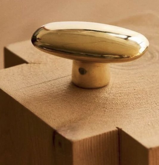 Brass knob detail on oak
