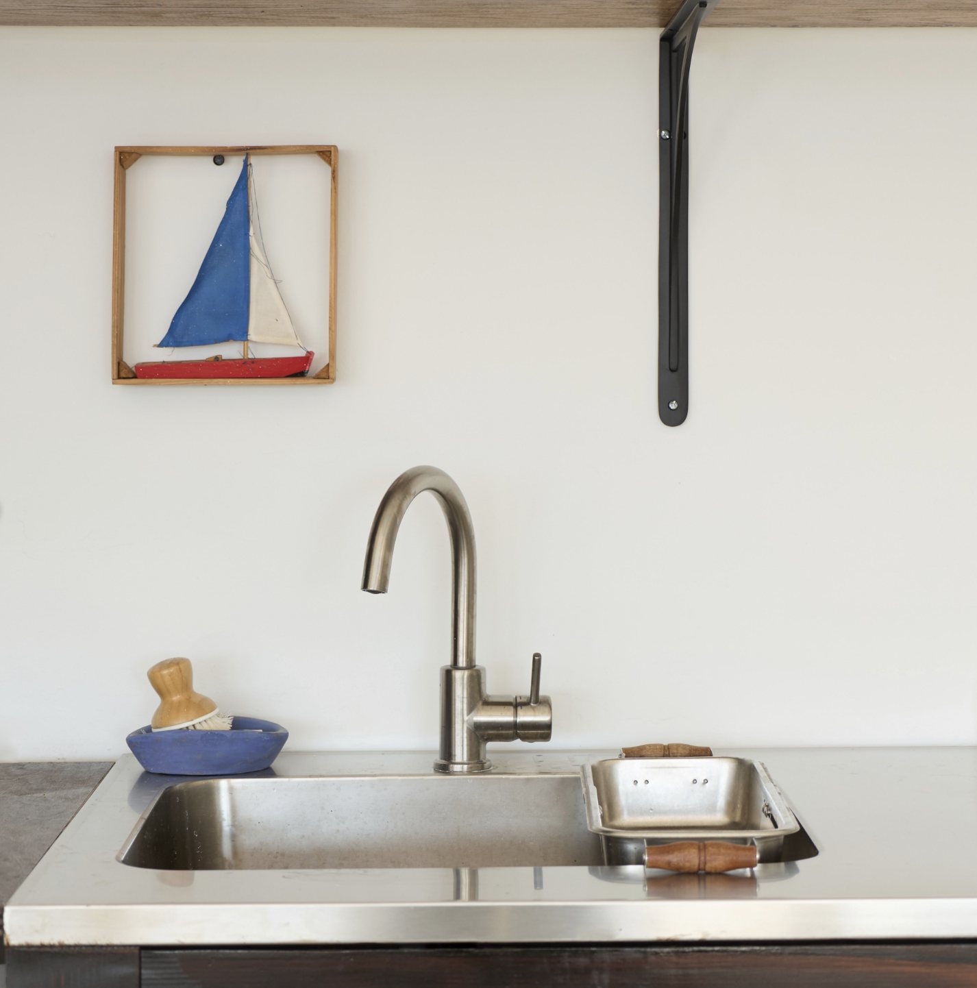 Kitchen sink detail with sailboat art